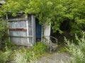 Old armchair near abandoned small house on the edge of the village. Royalty Free Stock Photo