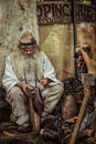 Old artisan making traditional Romanian shoes