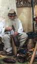 Old artisan making traditional Romanian shoes