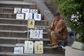 Old Artist Selling Japanese Calligraphy on Steps in Tokyo in Japan