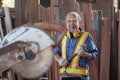 An old Asian carpenter is working to order in his own wood factory. With peace of mind by using hand tools including saws, wood Royalty Free Stock Photo