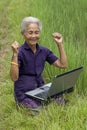 Old Asian with laptop