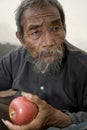 Old asian man with apple Royalty Free Stock Photo