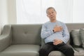 An old Asian man with chest pain was suffering from a heart attack, having difficulty breathing Royalty Free Stock Photo