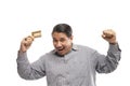 old asian man holding credit card with shrugging shoulders fist pump gesture Royalty Free Stock Photo