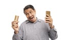 old asian man standing while holding phone and card white background Royalty Free Stock Photo