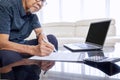 Old Asian man writing the insurance paper form Royalty Free Stock Photo