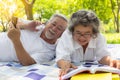 Old asian people, senior couple, elderly man and elderly woman get picnic in park. Old husband listening music, lay down on old wi