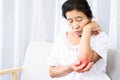 Old Asian woman suffering from tennis elbow pain hand holding her ache arm Royalty Free Stock Photo