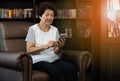 Old asian woman using smartphone.