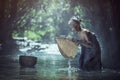 Old Asian woman working in creek Royalty Free Stock Photo