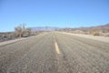 Old asphalt road going through desert