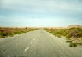 old asphalt road in the middle of the desert in the Kyzylkum desert.