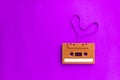 Old audio cassette tape with film shape heart on pink background Royalty Free Stock Photo