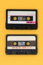 Old audio tape cassette on a bright yellow background. Top view, old technology concept Royalty Free Stock Photo