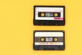 Old audio tape cassette on a bright yellow background. Top view, old technology concept Royalty Free Stock Photo