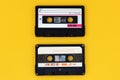 Old audio tape cassette on a bright yellow background. Top view, old technology concept Royalty Free Stock Photo