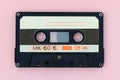 Old audio tape cassette on a pink background. Top view, old technology concept Royalty Free Stock Photo