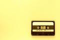 Old audio tape cassette, top view. Old technology concept. Yellow color Royalty Free Stock Photo