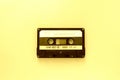 Old audio tape cassette, top view. Old technology concept. Yellow color Royalty Free Stock Photo
