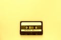 Old audio tape cassette, top view. Old technology concept. Yellow color Royalty Free Stock Photo