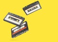 Old audio tape compact cassette isolated on yellow background Royalty Free Stock Photo