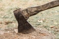 Old ax with a cracked handle in a wooden stump Royalty Free Stock Photo