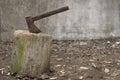 An old ax stuck in a tree trunk