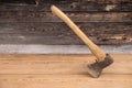 Old ax with a wooden handle stuck in wooden log. Concept for woodworking or deforestation. Selective focus. Royalty Free Stock Photo
