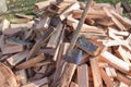 Old axe standing against a piled pieces of firewood Royalty Free Stock Photo