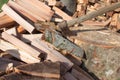 Old axe standing against a piled pieces of firewood. Axe stuck in a stump Royalty Free Stock Photo