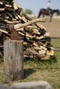 Old axe stuck in stump near woodpile - farm in Russia Royalty Free Stock Photo