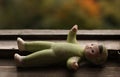 Old baby-doll lying on the window-sill