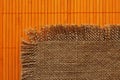 Old backing of burlap on the orange bamboo mat