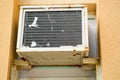 Old bad broken rectangular substandard rusty air conditioner for cooling air in summer Royalty Free Stock Photo