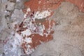 Old badly damaged gray concrete wall with spots of red and white paint. rough surface texture Royalty Free Stock Photo