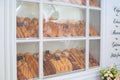 Old bakery window. Freshly baked bread and rolls are sold in bakery window. Showcase with traditional french pastries. bakery prod Royalty Free Stock Photo