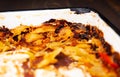 Old baking tray. Burnt during cooking. Failed dish. Homemade lasagne with cheese