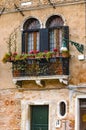 Old balconies in a Venice colorful building with red flowers Royalty Free Stock Photo