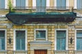 An old balcony in disrepair covered with a green professional construction protective net. Facade of a residential building in St. Royalty Free Stock Photo