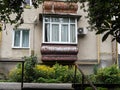 Old balcony with new windows on the facade of the building Royalty Free Stock Photo