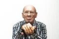 Old bald man in glasses shows middle finger.