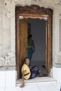 Old balinese woman sitting in door