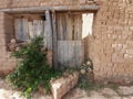 Old Balkan house wooden door and a clay wall. Vintage village clay bricks wall