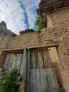 Old Balkan house wooden door and a clay wall. Vintage village clay bricks wall