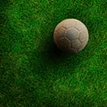 Old ball on green grass soccer field Royalty Free Stock Photo