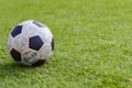 Old ball soccer on new green grass-ground Royalty Free Stock Photo