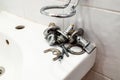 old ball valves and fixtures lie on edge of sink Royalty Free Stock Photo