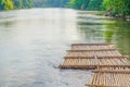 Old bamboo raft is floating on the river in the thailand Royalty Free Stock Photo