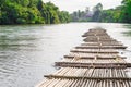 Old bamboo raft is floating on the river in the thailand Royalty Free Stock Photo